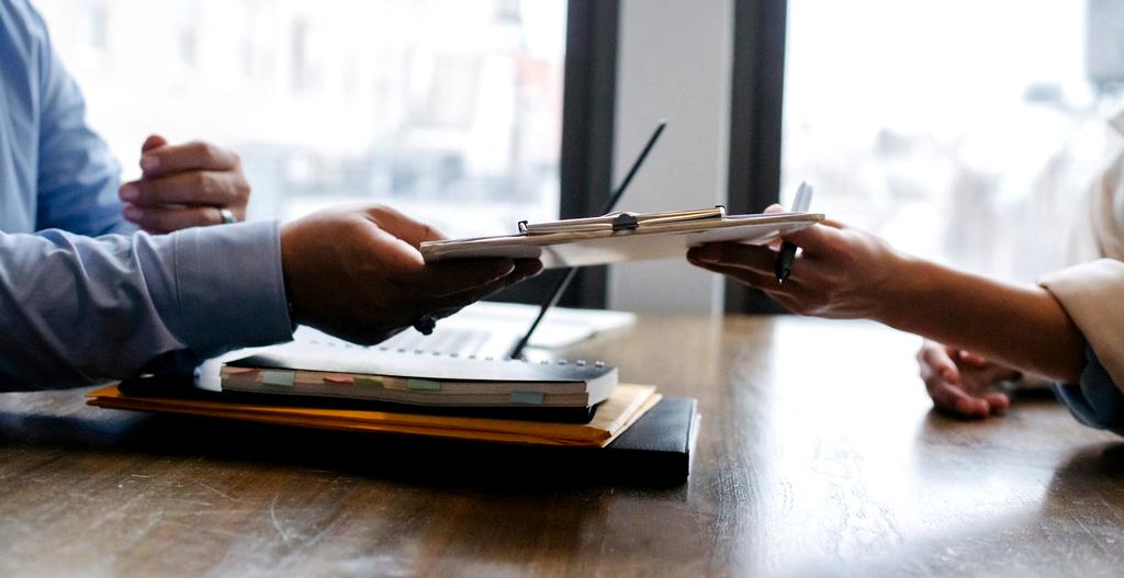 Modern professional workspace with laptop and resume documents